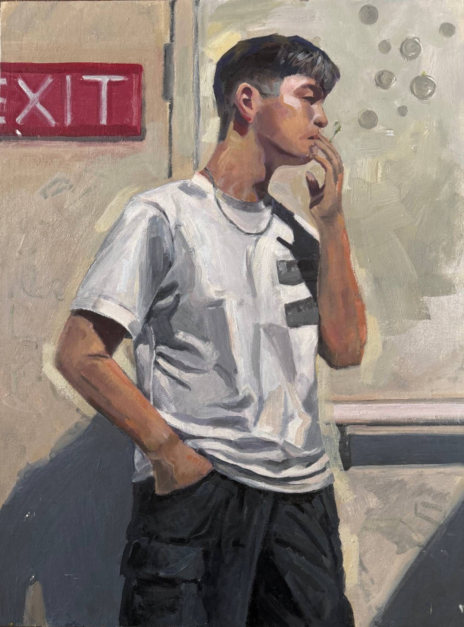 Acrylic self-portrait of the artist as a young man in a white T-shirt and dark cargo pants, one hand in his pocket and the other raised to his mouth, standing in profile against a cream wall with a red EXIT sign at upper left and strong diagonal shadows.
